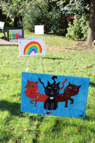 colorful lawn signs on green grass