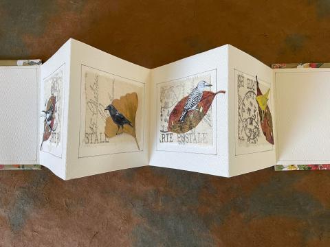 accordion book with bird collage and laves