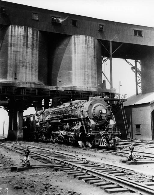 Black and white photo of a train at the selkirk rail yard coaling tower